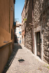 Fototapeta na wymiar a cobbled street with traditional old houses in the medieval old town of Viterbo, Lazio, Italy 