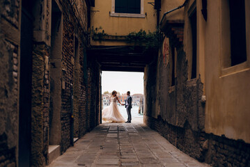 Beautiful bride and groom dancing at the old Venice city with wonderful architecture. Wedding day...