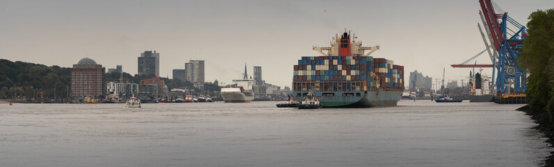 Panorama of the port of Hamburg with container ships and skyline in bad weather