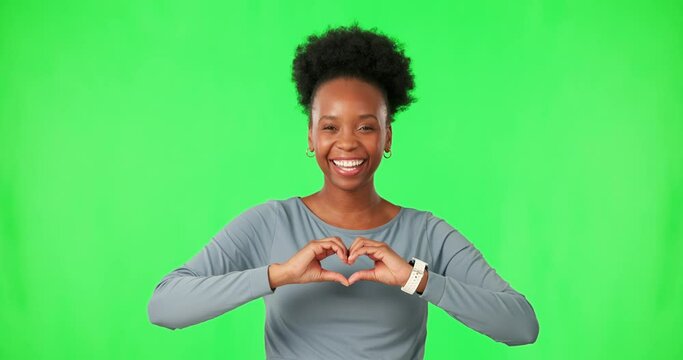Black woman with smile on face, heart hands and green screen with care, kindness or gesture. Thank you, like and happy girl with love hand sign, emoji or icon on isolated on color background portrait