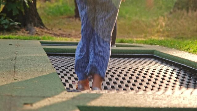 Happy Caucasian Kids Jumping on Trampoline Springboard at Outdoor Playground