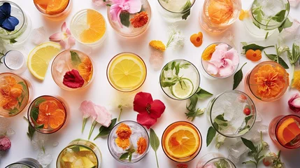   a table topped with lots of glasses filled with different types of drinks and flowers on top of each of the glasses. © Anna