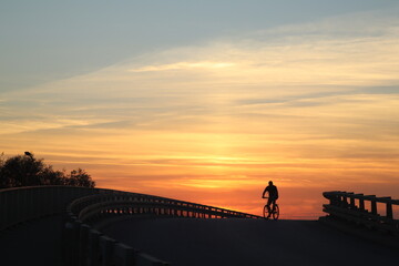 man on the bike in a sunset