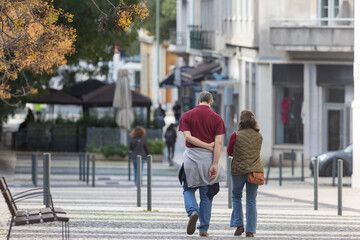 A man and a woman walking down a street