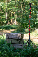 Wooden military crates for weapons and ammunition laid in the forest.