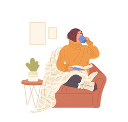Young woman wrapped in plaid, drinking hot tea and reading book at home enjoying cozy autumn