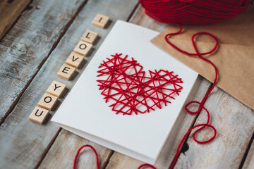 Concept of love message. I love you words written in wooden blocks. Idea for making handmade greeting cards with wooden red heart for Valentine's Day. Sweet cute bear for breakfast, envelope