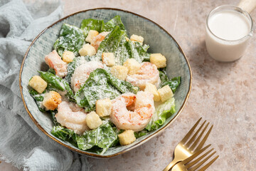 Fototapeta na wymiar Fresh caesar salad on bowl with parmesan cheese and shrimps