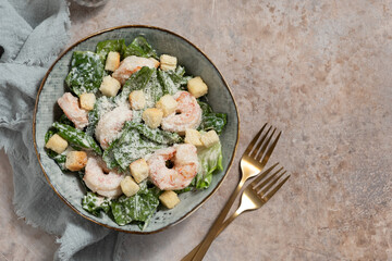 Fresh caesar salad on bowl with parmesan cheese and shrimps