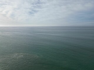 Obraz premium Beautiful aerial scene over large gray sea dunes with cloudy sky on the horizon