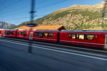 Red Bernina train enters St Moritz Station in Switzerland - 677364854
