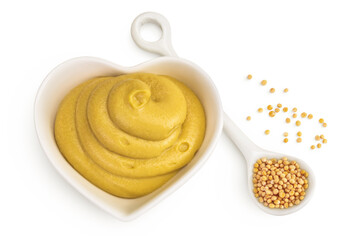 Mustard sauce in ceramic bowl with seed isolated on white background. Top view. Flat lay