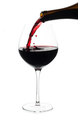 Pouring red wine in Burgundy glass (Merlot) isolated on white