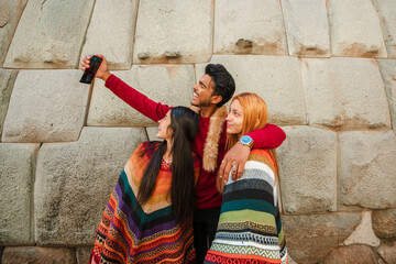 group of peruvian happy friends taking a selfie in cusco peru - obrazy, fototapety, plakaty
