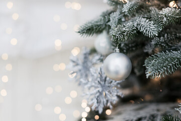 Fototapeta na wymiar Christmas tree with silver white decorations
