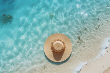 Close-up view of beach hat in clear sea water with beautiful light pattern on beach. Summer tropical vacation concept.