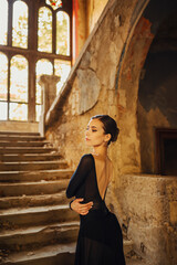 Ballerina in backless dress posing while expressing her body