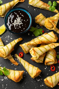 Fried Laksa cones with vegetables, lemongrass, coconut on rustic stone board