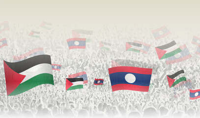 Palestine and Laos flags in a crowd of cheering people.