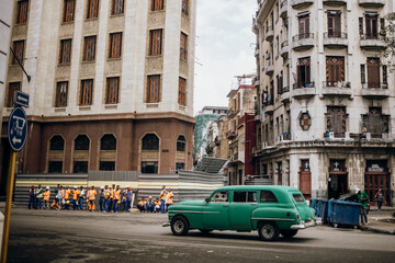 Urban Intersection with Classic Green Car in Havana, Cuba
