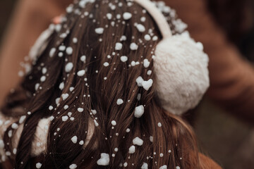 Little girl rejoices at first snow outdoor in winter Christmas day