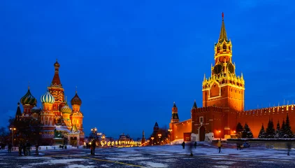 Foto auf Acrylglas Moskau View of illuminated Spasskaya Tower and Saint Basils Cathedral on Red Square in Moscow on winter evening, Russia