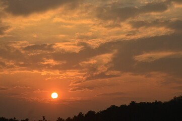 Beautiful shot of the sunset behind the clouds in the evening