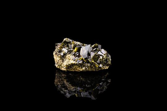 epidote crystals cluster isolated on black background. macro detail close-up rough raw unpolished semi-precious gemstone