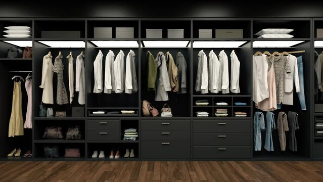 Luxury wardrobe, stylish clothes organised on shelves in a large walk-in closet interior.