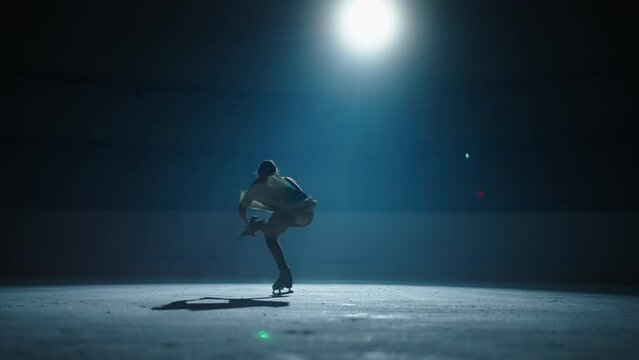 Professional Figure Skating, Silhouette Of Graceful Woman Figure Skater Skating Alone In Ice Rink