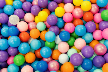 Pool of multicolored balls in close-up. Entertainment for children in the children's playroom.