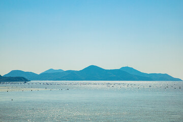 Dongtou Islands, Dongtou District, Wenzhou City, Zhejiang Province - seascape of islands and fishing boats against the blue sky
