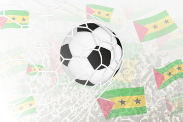 National Football team of Sao Tome and Principe scored goal. Ball in goal net, while football supporters are waving the Sao Tome and Principe flag in the background.