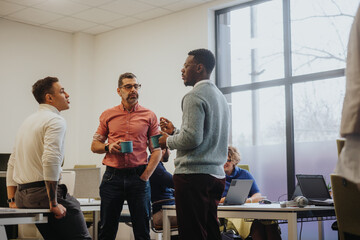 Diverse colleagues collaborate in a modern office discussing growth, market research, and profitability. Smart use of technology and teamwork lead to business success.