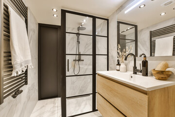 a modern bathroom with white marble walls and black framed mirrors on the wall above the sink is a wooden cabinet