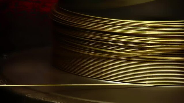 Metal Gold Wire is Coiling into the Big Spool. Copper Production Line. Copper Rod. Metallurgy. Heavy Industry. Metal Tube Production at Factory. Hot Metal. Steel Making Work. Close Up