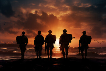 Obraz premium soldiers on a beach against sunset silhouette