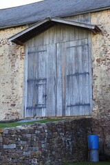 Vertical shot of the old wooden doors of a barn.