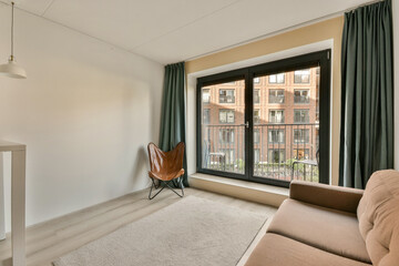 a living room with a couch, chair and window looking out onto the cityscapearrons com