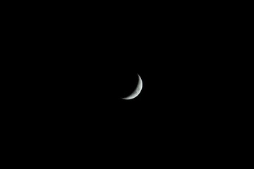 Obraz na płótnie Canvas Crescent moon against black backcground