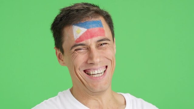Man with a philippine flag painted on the face smiling