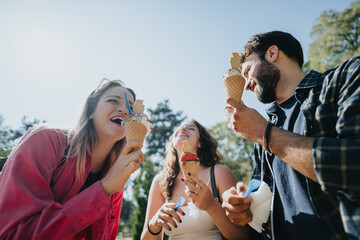 Friends enjoying nature, having carefree conversations in the park, and eating ice cream. Their positive energy and joyful expressions capture the essence of a sunny day spent together.