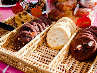 Variety of cookies on woven rattan divided serving tray compartments party platter outdoor table with Grateful, Blessed, Thanks decoration words Thanksgiving event in Dallas, Texas, USA