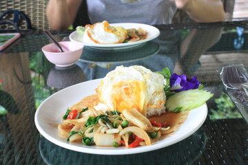 Stir-fried seafood with basil and fried egg, Thai food