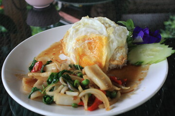 Stir-fried seafood with basil and fried egg, Thai food