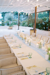 Festive long table with a strip of blue fabric in the middle
