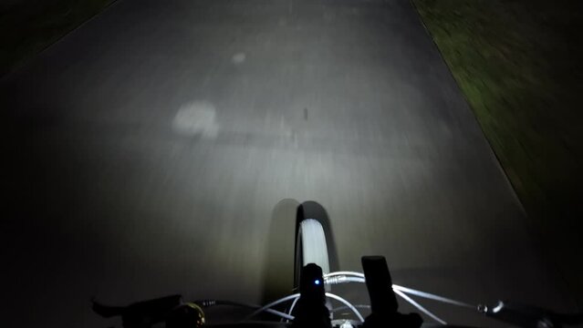 Facing down bike riding night with bright headlight lumens