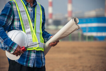 Senior Electrician engineer man hand holding red Walkie talkie communicate wear White hardhat at Power stations manufacturing electrical plant. Technician worker blue hard hat helmet Engineer industry