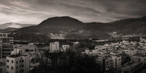 Retro-style mountain town cityscape in black and white colors, an aerial landscape at foggy winter morning in Wonju-si, Gangwon-do, South Korea