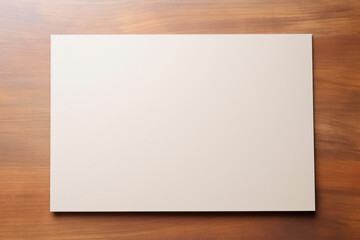 白紙の横向きのA4用紙が木の机の上に置かれているモックアップ